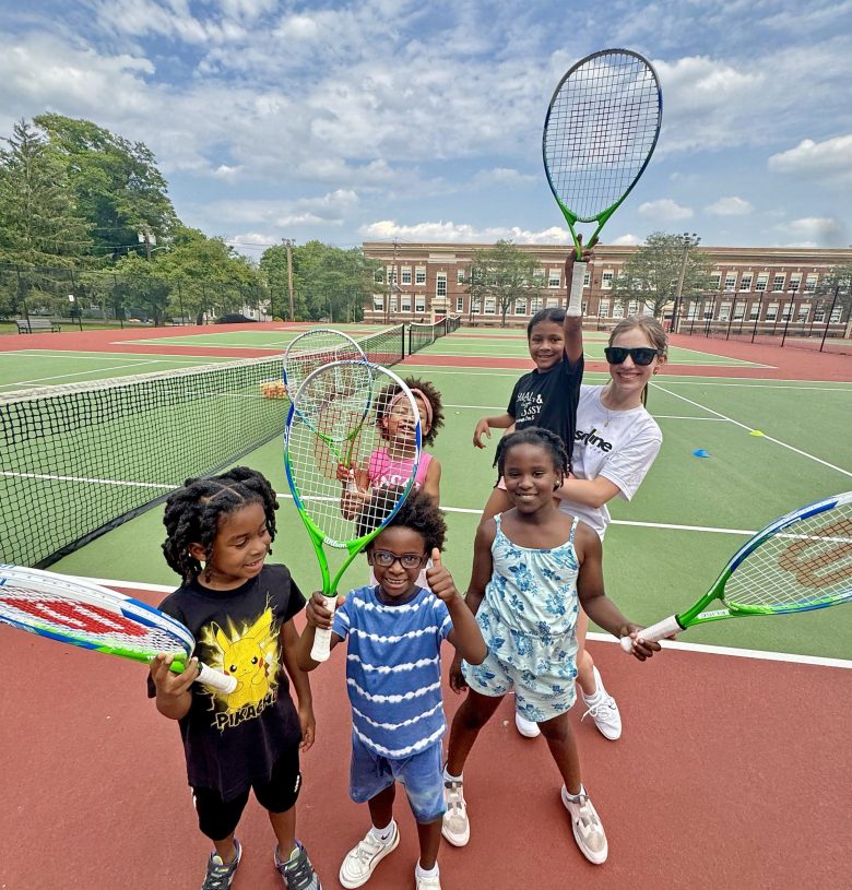 Montclair High School rising senior Sayan Goodrich  and students who participated in the Baseline Buddies show off their tennis racquets.