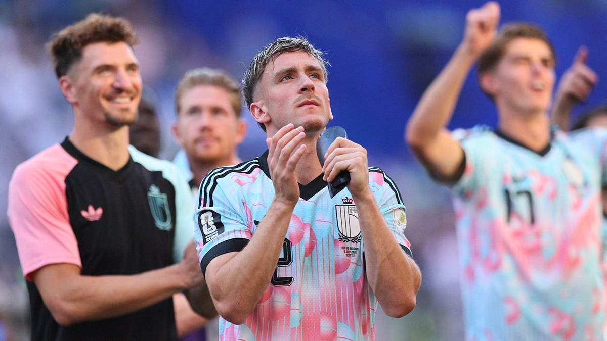 Alexis Saelemaekers applauds fans after the match.