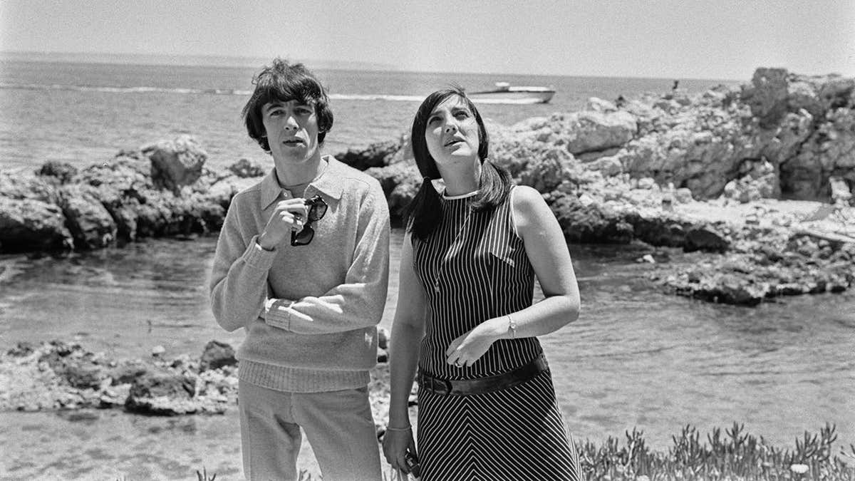 Bill Wyman and his first wife walking on the beach.