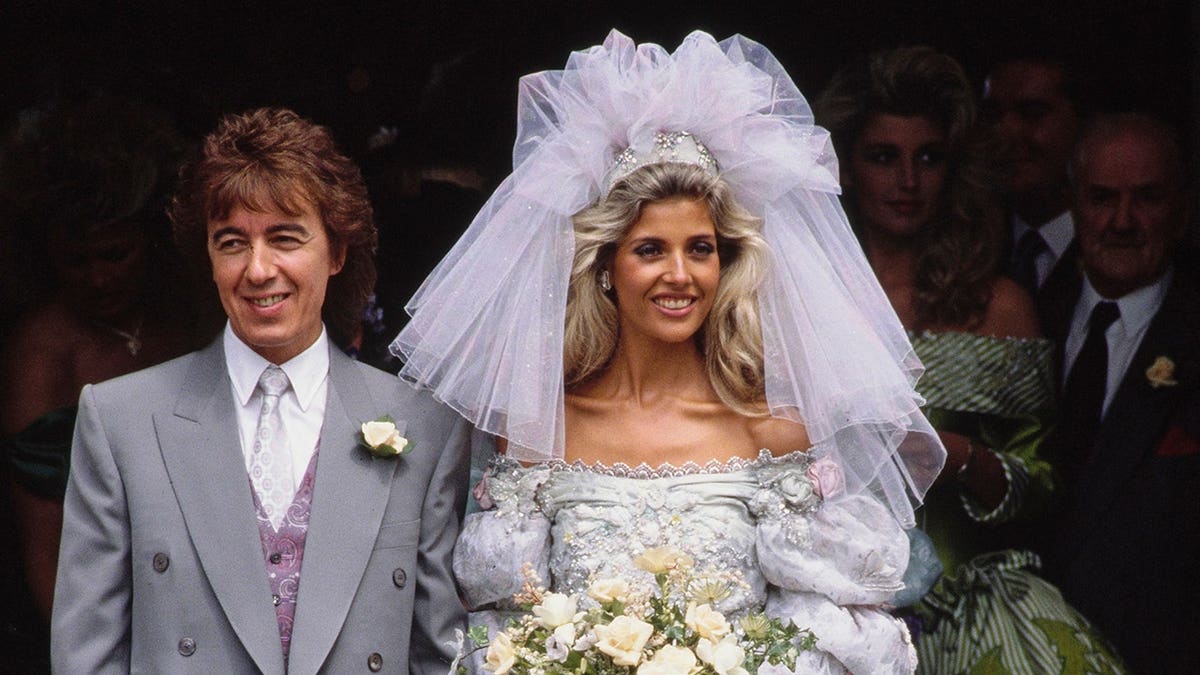 Bill Wyman and Mandy Smith standing outside a church on their wedding day.