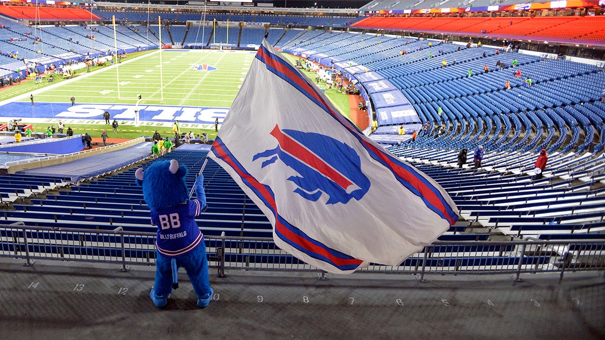 Buffalo Bills fans leave Bills Stadium as a mascot waves a flag after an NFL divisional round football game against the Baltimore Ravens Saturday, Jan. 16, 2021, in Orchard Park, N.Y. The Bills won 17-3. (AP Photo/Adrian Kraus)