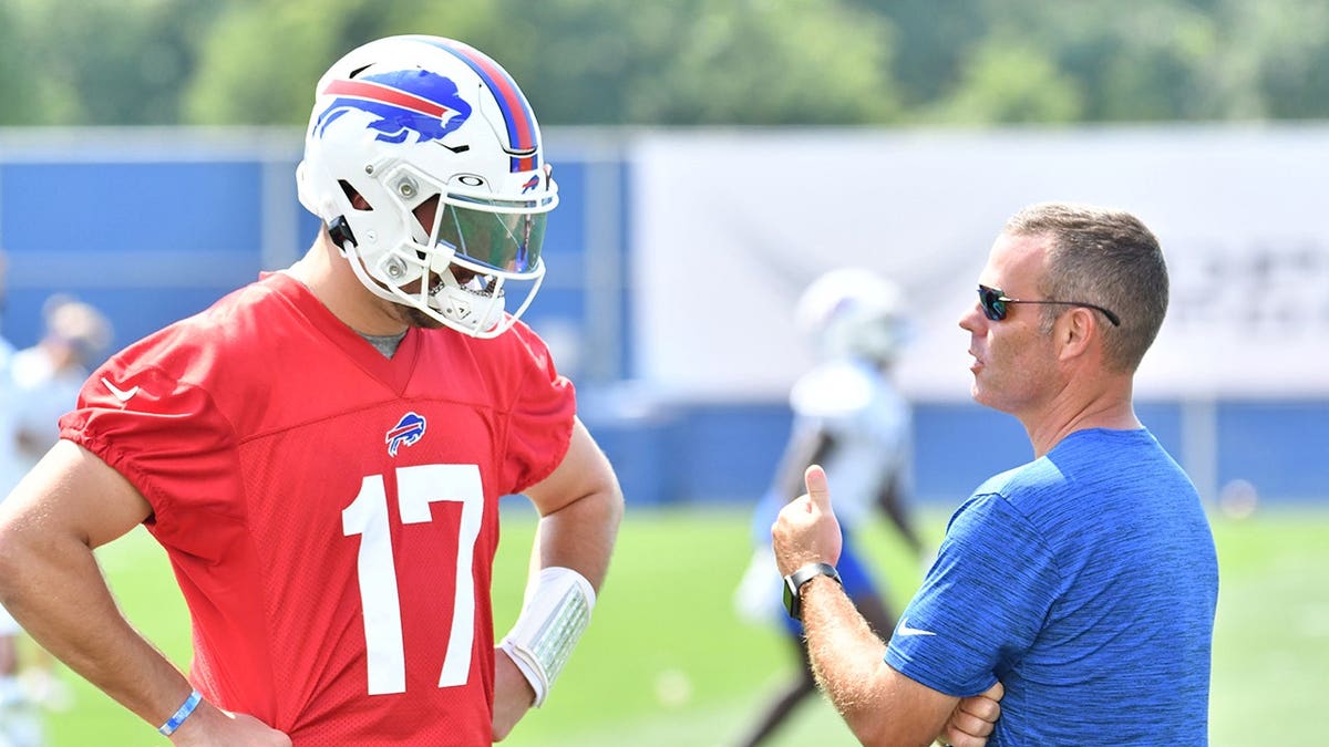 Bills general manager Brandon Beane talks with quarterback Josh Allen