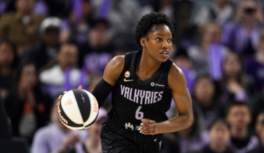 A female basketball player wearing a black "Valkyries" jersey with number 6 is dribbling a black and white basketball on court.