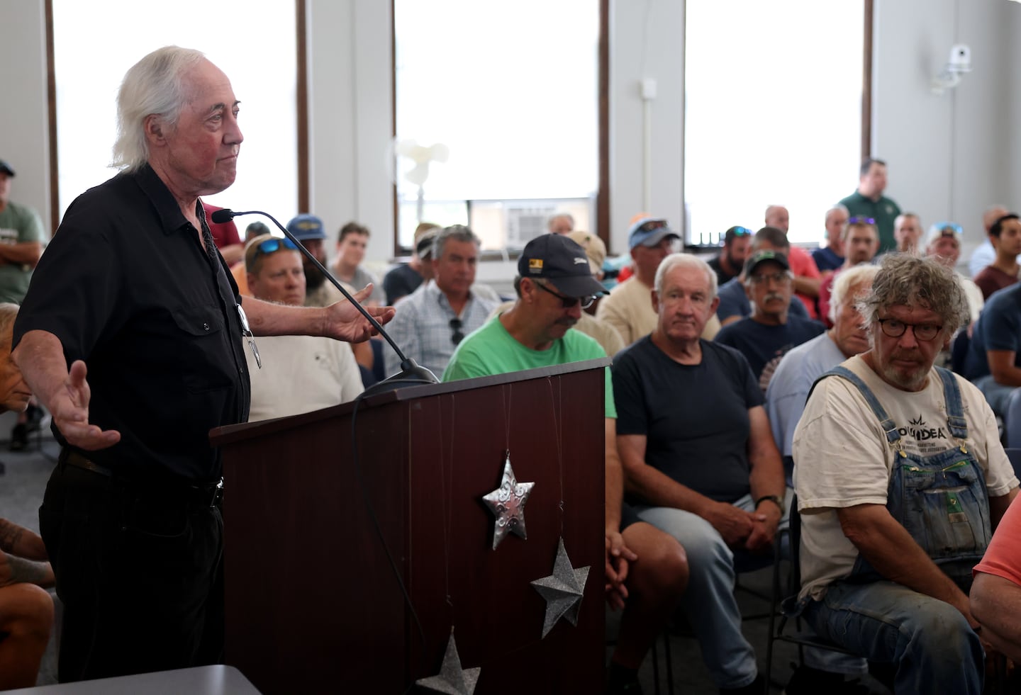 Michael Matheson, a clam digger, questioned officials during the meeting.