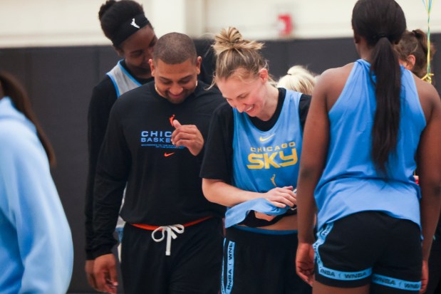 Chicago Sky coach Tyler Marsh, left, and guard Courtney Vandersloot laugh at the end of the first day of training camp April 27, 2025, at Sachs Recreation Center in Deerfield. (Eileen T. Meslar/Chicago Tribune)