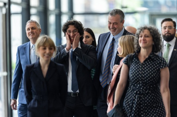 "Broadview Six" defendants Michael Rabbitt, from left, Kat Abughazaleh and Andre Martin laugh together as they leave the Dirksen U.S. Courthouse following a hearing on May 21, 2026. (Josh Boland/Chicago Tribune)