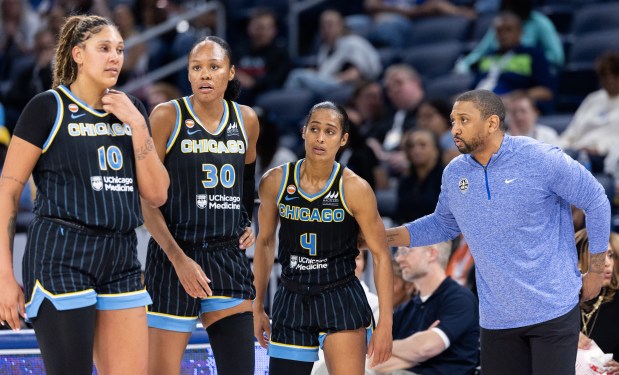 The Chicago Sky's Kamilla Cardoso, from left, Azurá Stevens and Skylar Diggins listen to coach Tyler Marsh during a timeout in a game against the Toronto Tempo on May, 27, 2026, at Wintrust Arena. (Josh Boland/Chicago Tribune)