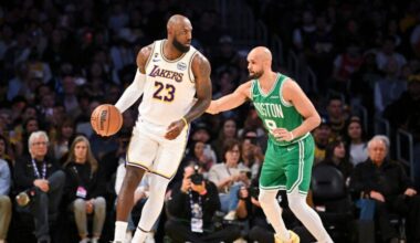 Los Angeles Lakers forward LeBron James dribbles as Boston Celtics guard Derrick White plays defense during the first half of an NBA basketball game, Sunday, Feb. 22, 2026, in Los Angeles.
