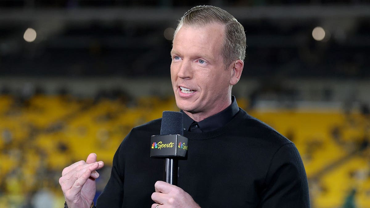 Chris Simms stands on the field at Acrisure Stadium before the Steelers host the Packers.