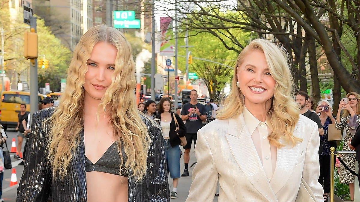 Sailor Brinkley-Cook wearing black walking alongside her mother Christie Brinkley in beige at New York City's Lincoln Center.