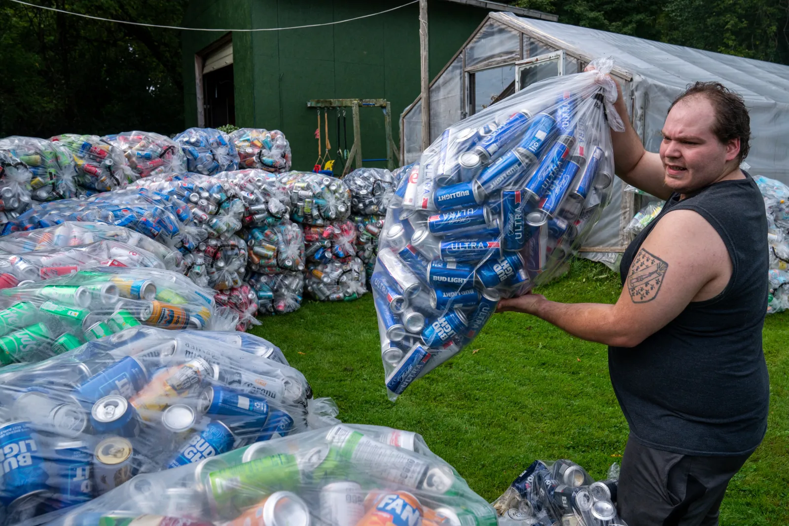 An employee of the Tenney Bottle Redemption Center stacks returnable bottles on September 8, 2023 in East Charlotte, Vermont.