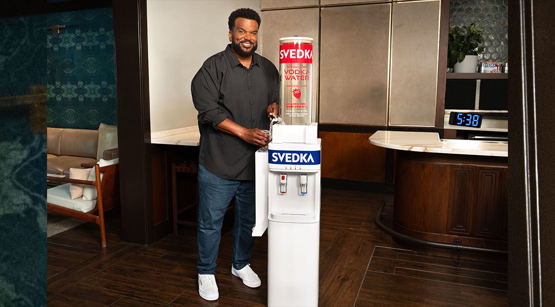 Craig Robinson pouring a glass of svedka
