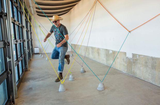 NoBo Art District's Director of Exhibits Nod Norkus gets airborne inside an installation at the NoBo Bus Stop Gallery last summer. First Friday will fill both North Boulder and downtown Boulder with exhibits galore this weekend. (Nod Norkus/Courtesy photo)