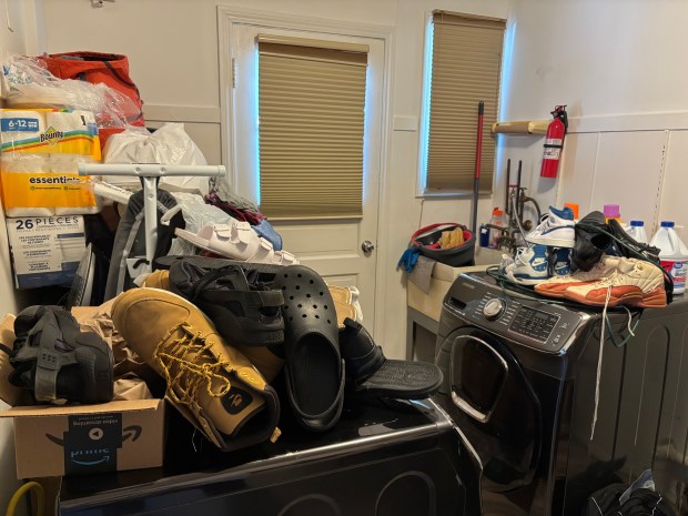 Shoes and other belongings are piled on top of the washer and dryer in Aleiya Jennings' home on Minocqua Street, Park Forest on July 6, 2026. (Evy Lewis/Daily Southtown)