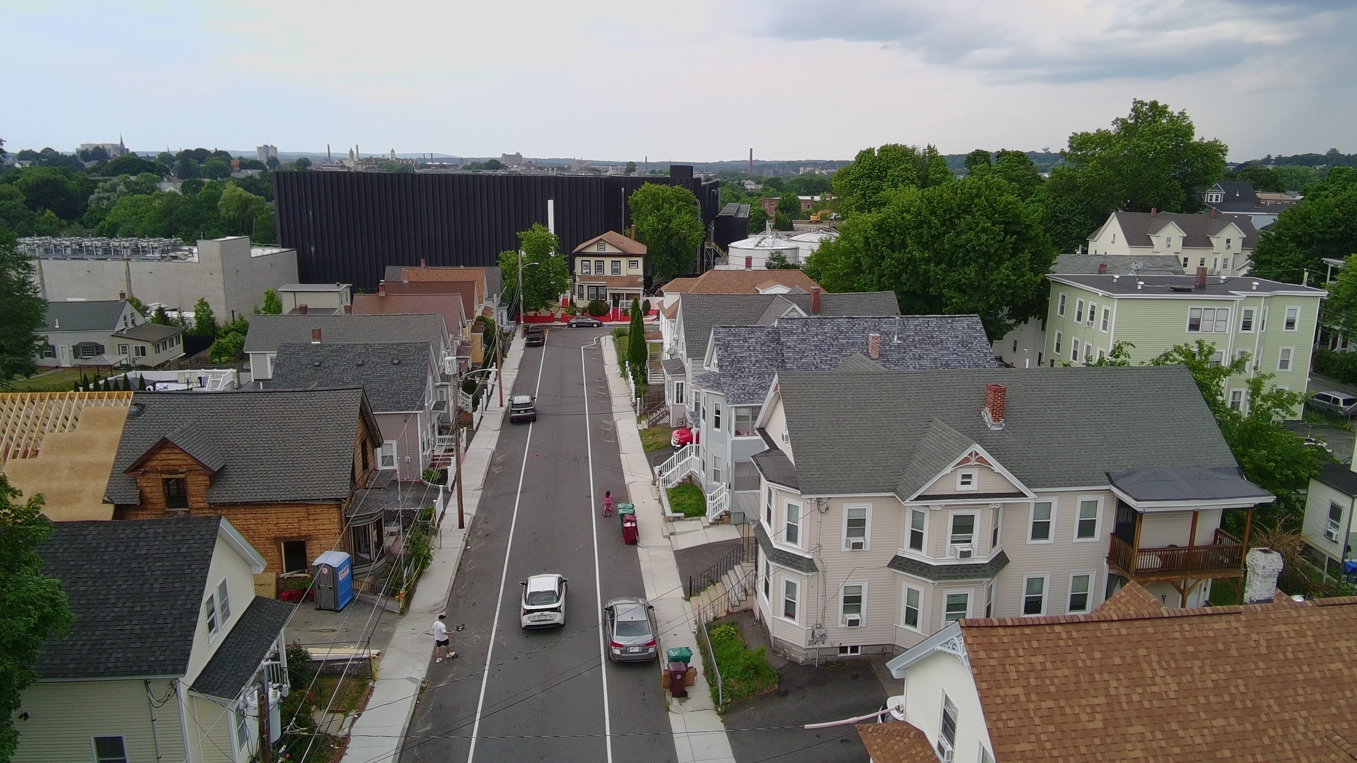 A data center and its backup diesel generators built by the Markley Group loom over a ballpark and residential neighborhood in Lowell, Massachusetts. Residents in both Lowell have sued over the noise