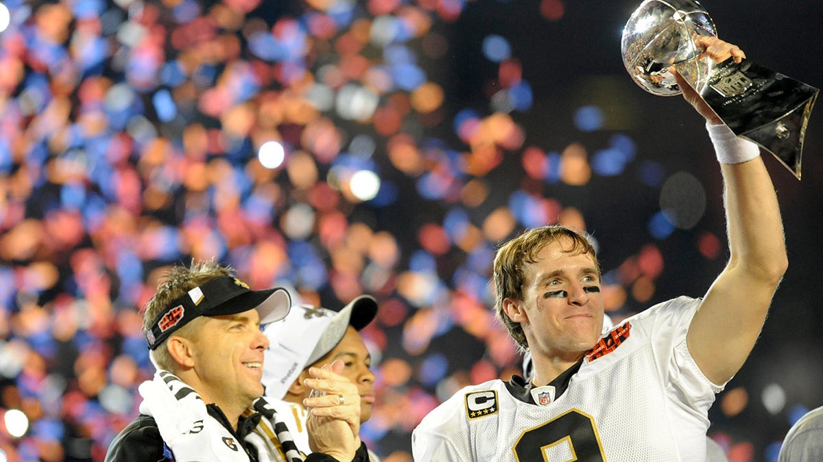Drew Brees holds the Vince Lombardi Trophy