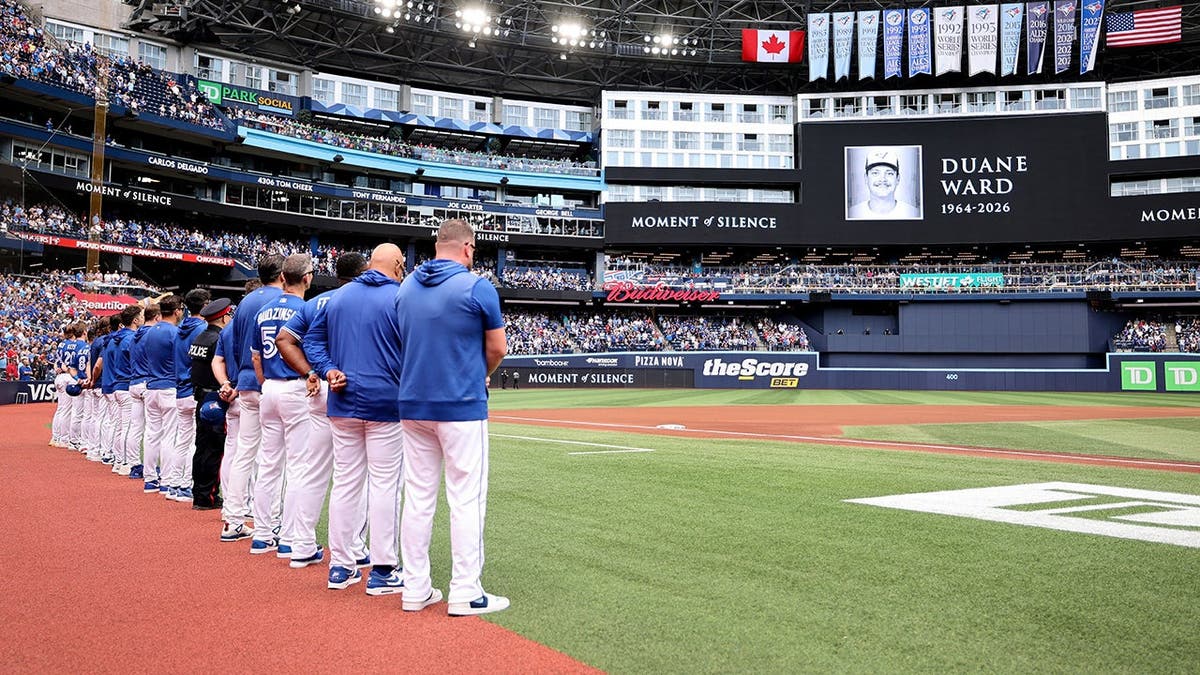 Toronto Blue Jays players stand during a moment of silence at Rogers Centre.