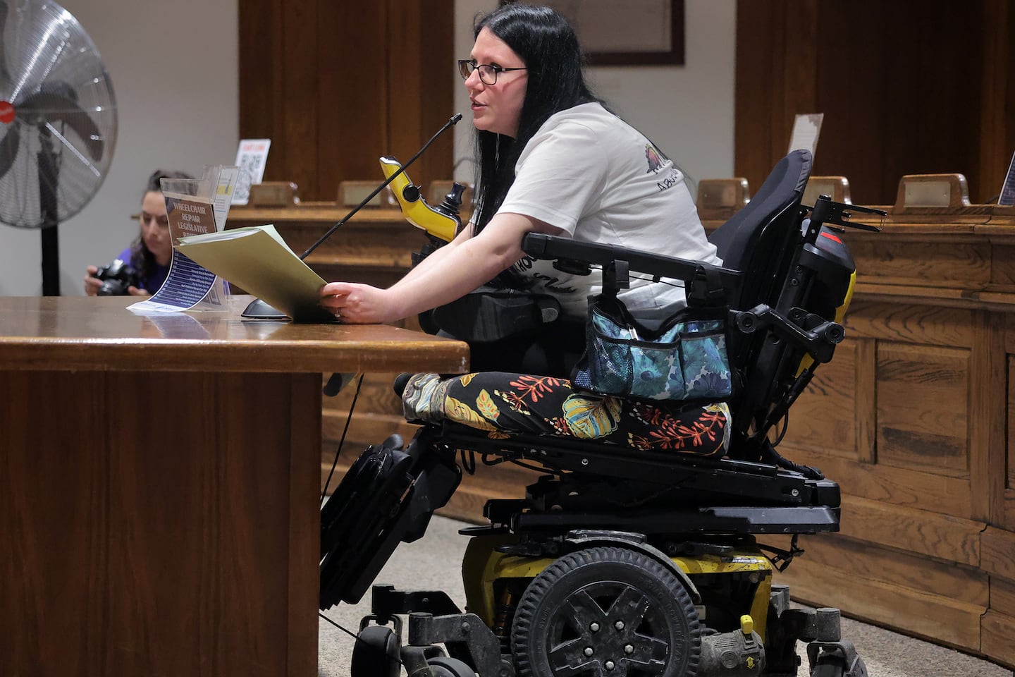 Organizer Destiny Maxam spoke at a hearing at the State House on March 11 to advocate for bills that would aim to facilitate repairs, reduce wait times, and hold manufacturers of wheelchairs accountable to their customers.