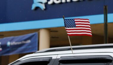 A car with the American flag passes Methodist Hospital-Jefferson Health during a Reopen Philly caravan on South Broad Street in South Philadelphia on Friday, May 8, 2020.