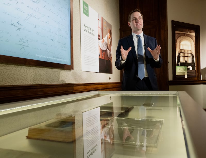 Spencer McBride, associate managing historian of the Joseph Smith Papers, stands by historical documents newly acquired from the Community of Christ and displayed at the Church History Museum in Salt Lake City on Monday, March 25, 2024.