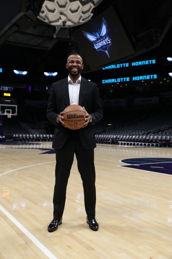 Jeff Peterson holds a basketball on the court.