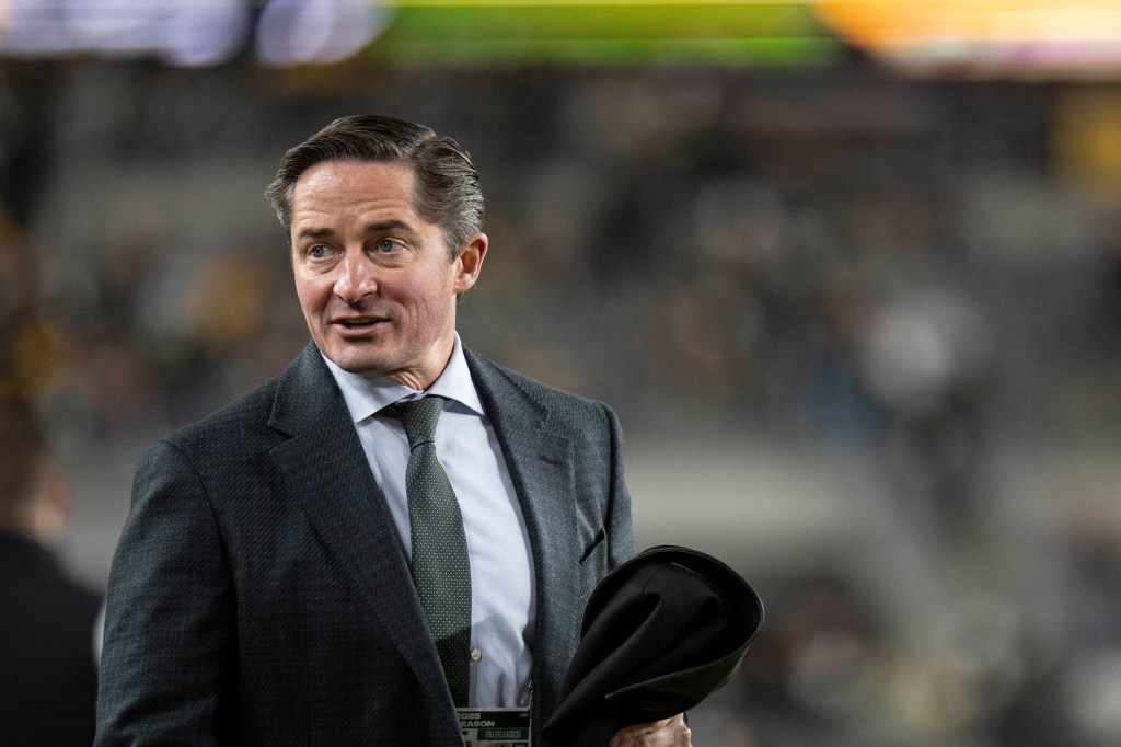 A man in a suit and tie at the Packers vs. Steelers game.