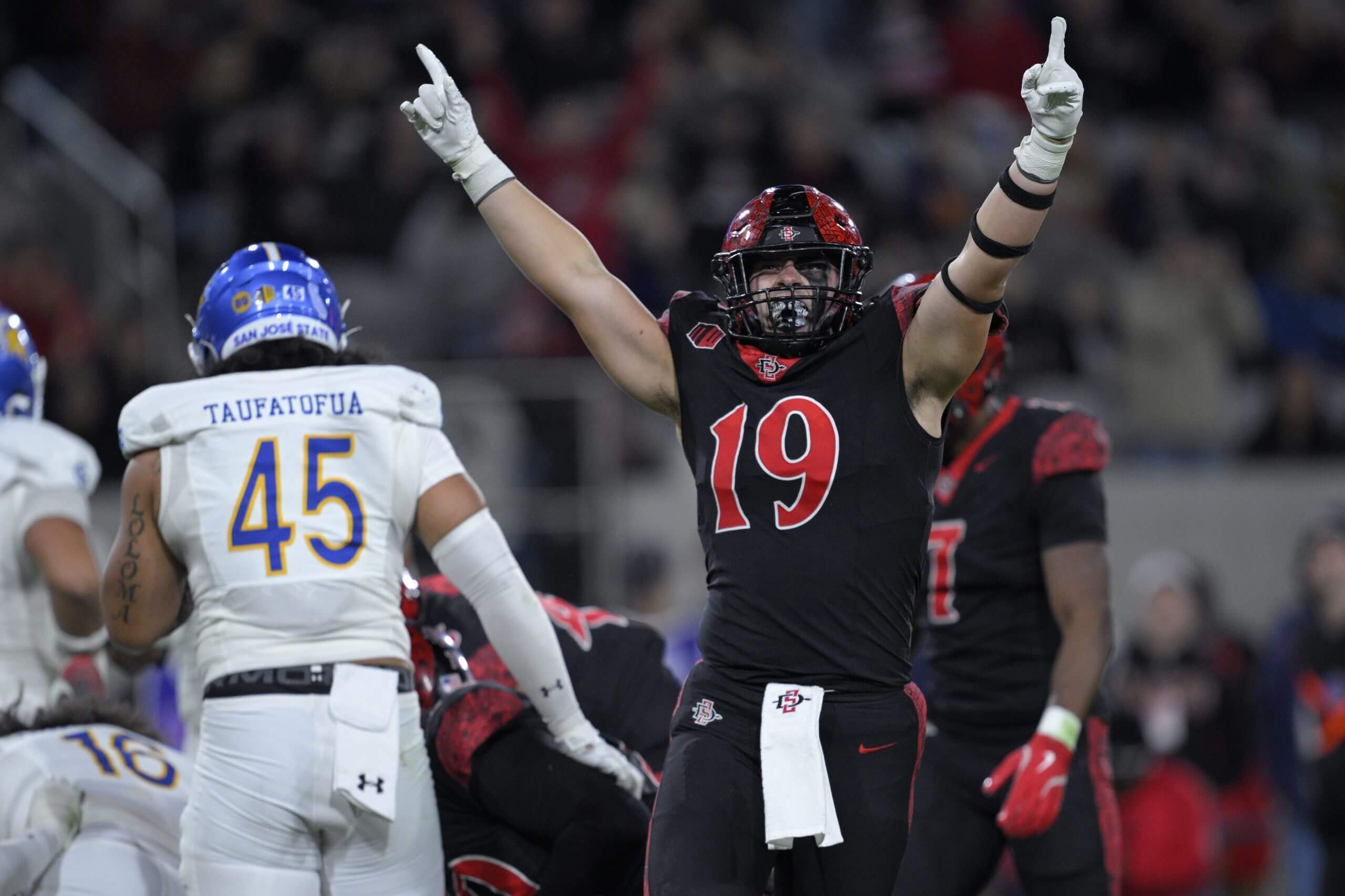 Seth Adams of San Diego State puts his arms in the air.