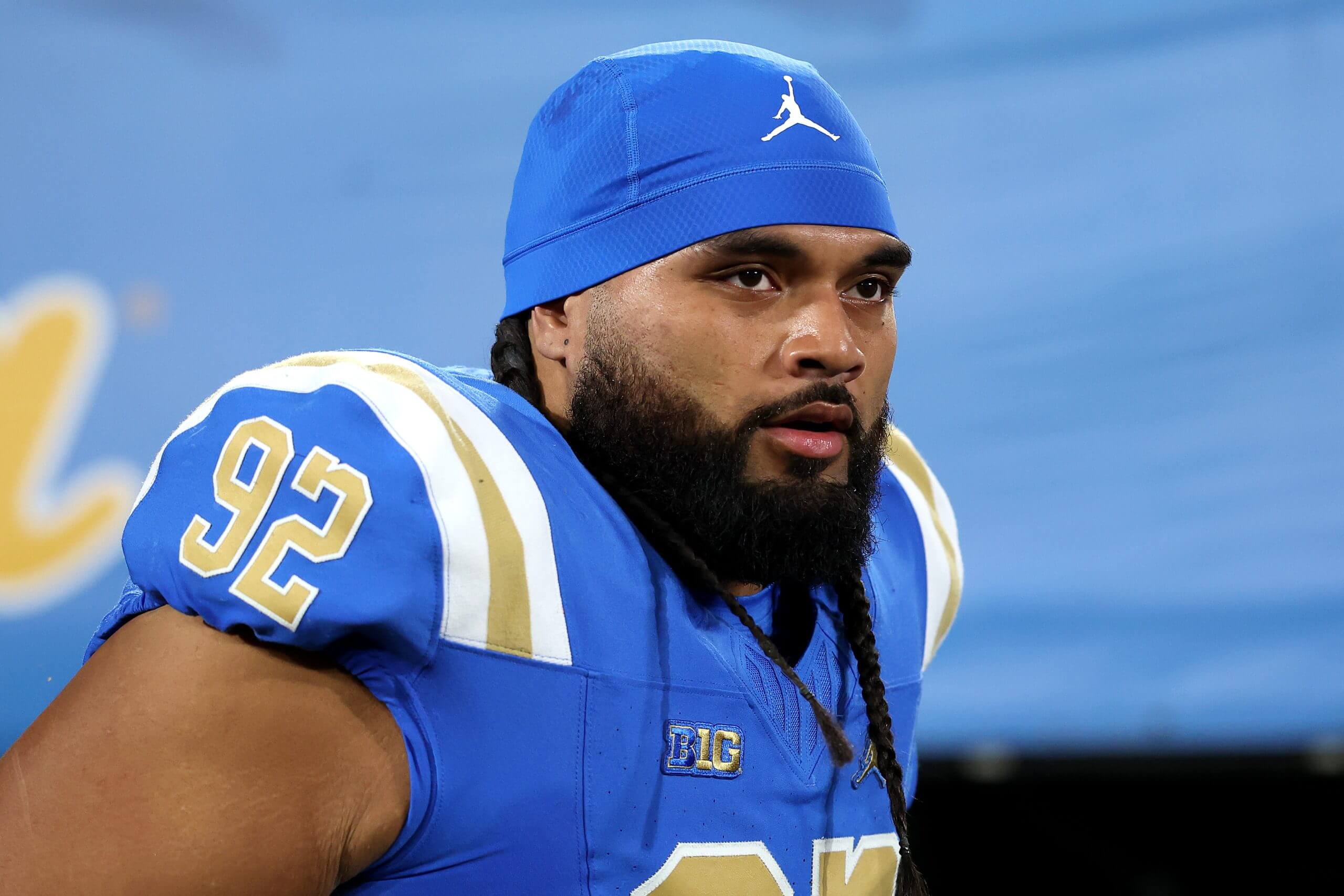 Former UCLA defensive lineman Siale Taupaki looks on during a game.