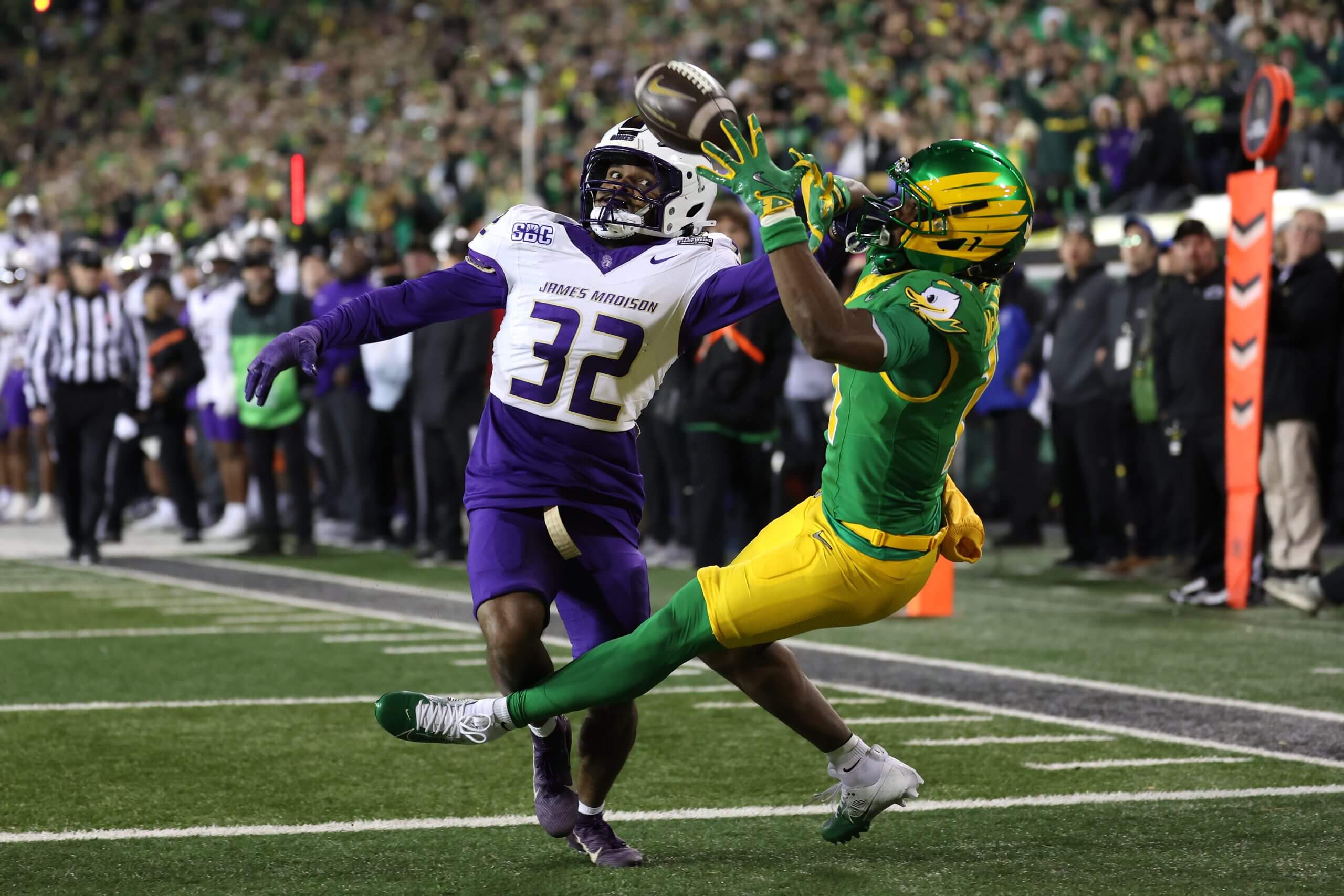 Jeremiah McClellan of Oregon catches a pass for a touchdown while defended by DJ Barksdale of James Madison