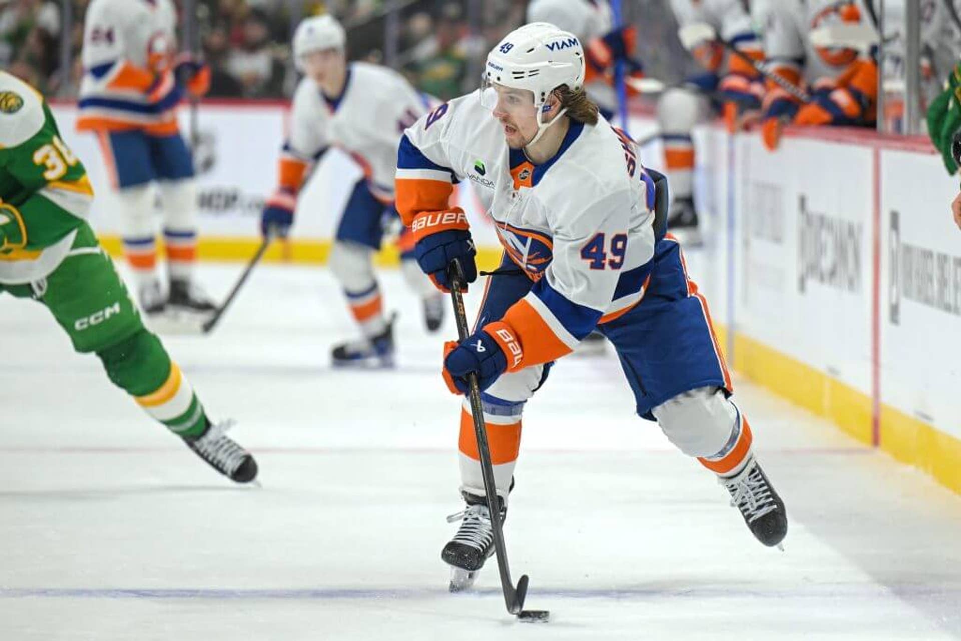 Wearing a white Islanders jersey and helmet, Maxim Shabanov skates with the puck during a Jan. 2026 game against the Minnesota Wild.