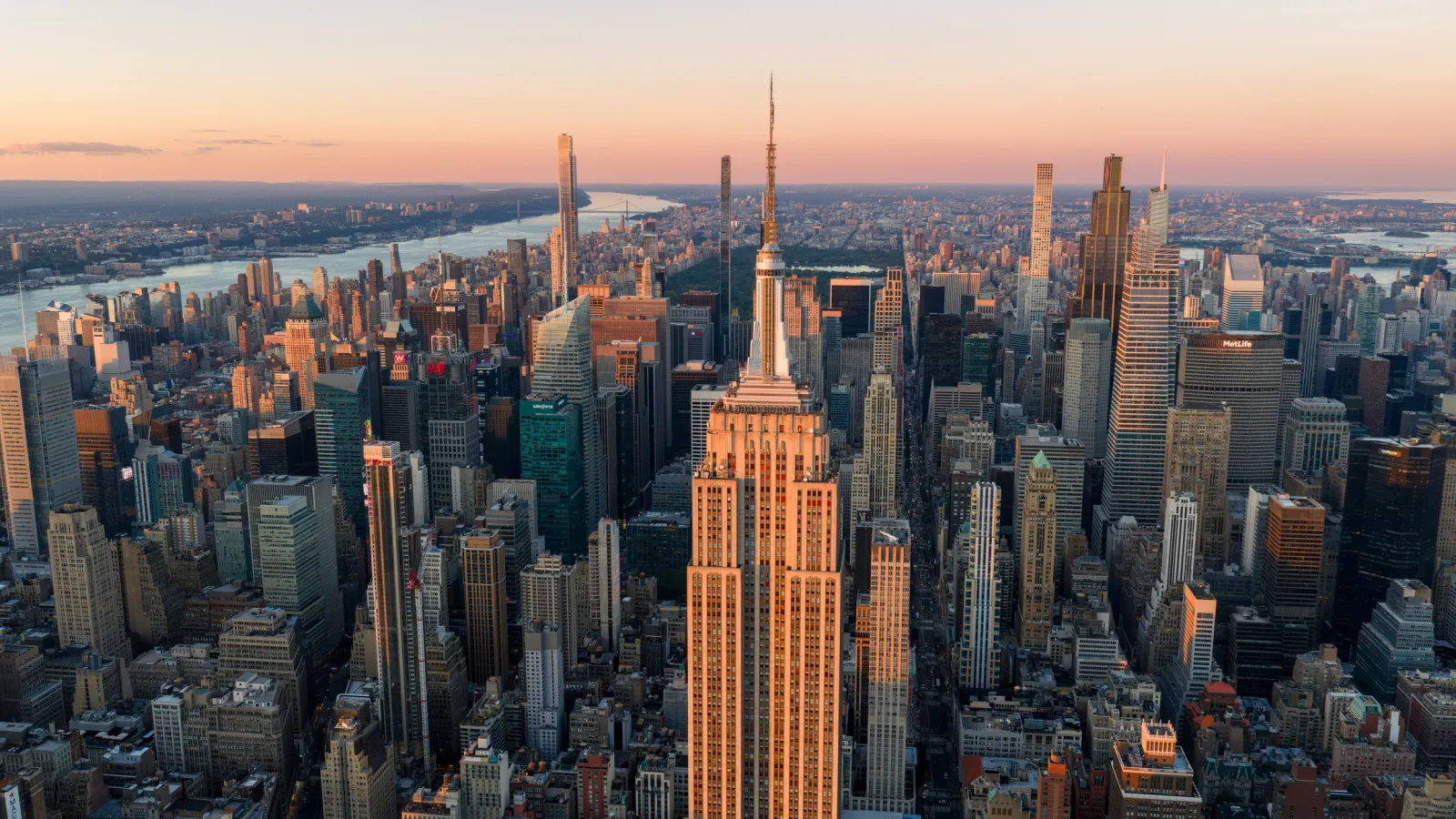 A view of the Midtown Manhattan skyline at sunset.