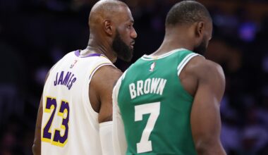 LeBron James talks to Jaylen Brown on the court.