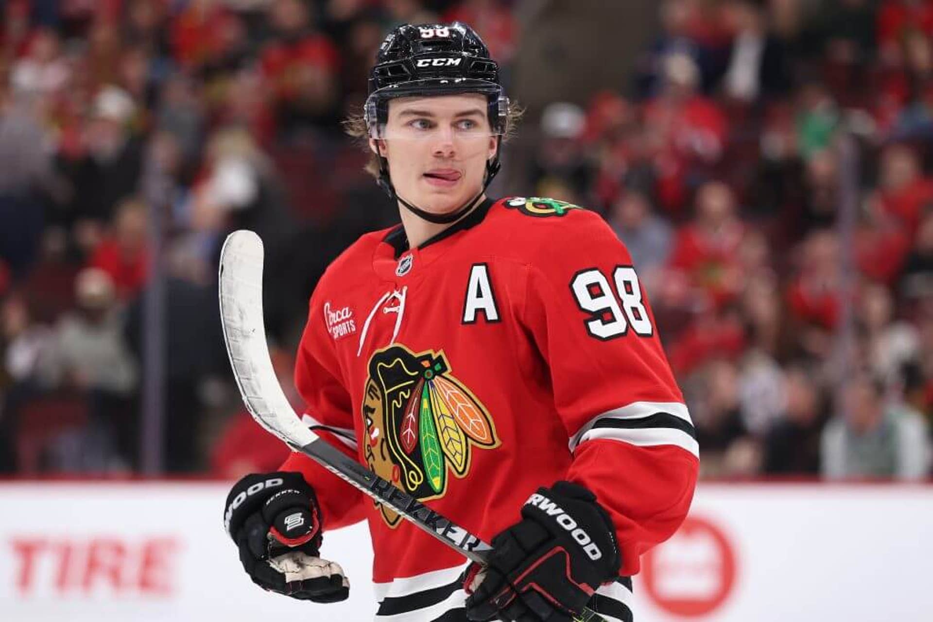 Connor Bedard holds his stick near the blade while turning during a Blackhawks game.