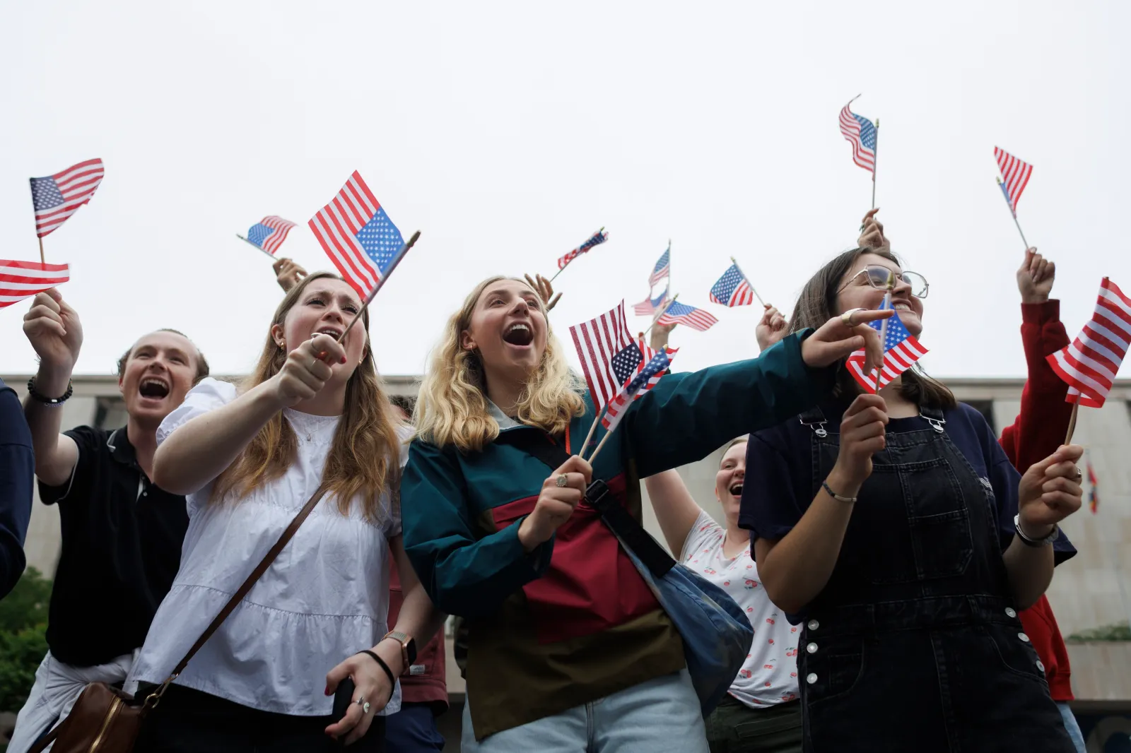 Attendees wave American flags during a Memorial Day parade in Washington, D.C., on May 25, 2026.