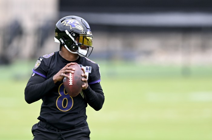 Lamar Jackson holds the ball and gets ready to throw a pass during minicamp