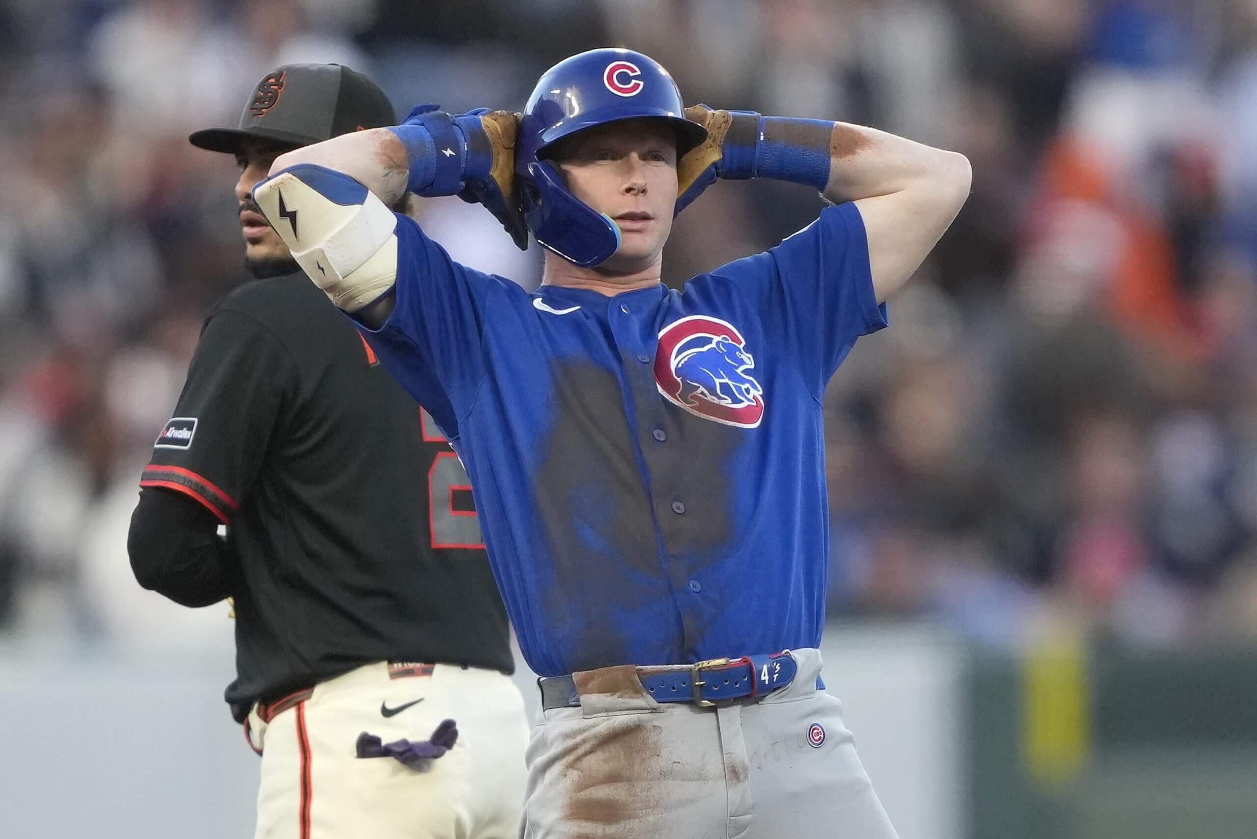 Pete Crow-Armstrong of the Chicago Cubs, in a blue jersey top and his hands behind his head, reacts after hitting a double against the San Francisco Giants.