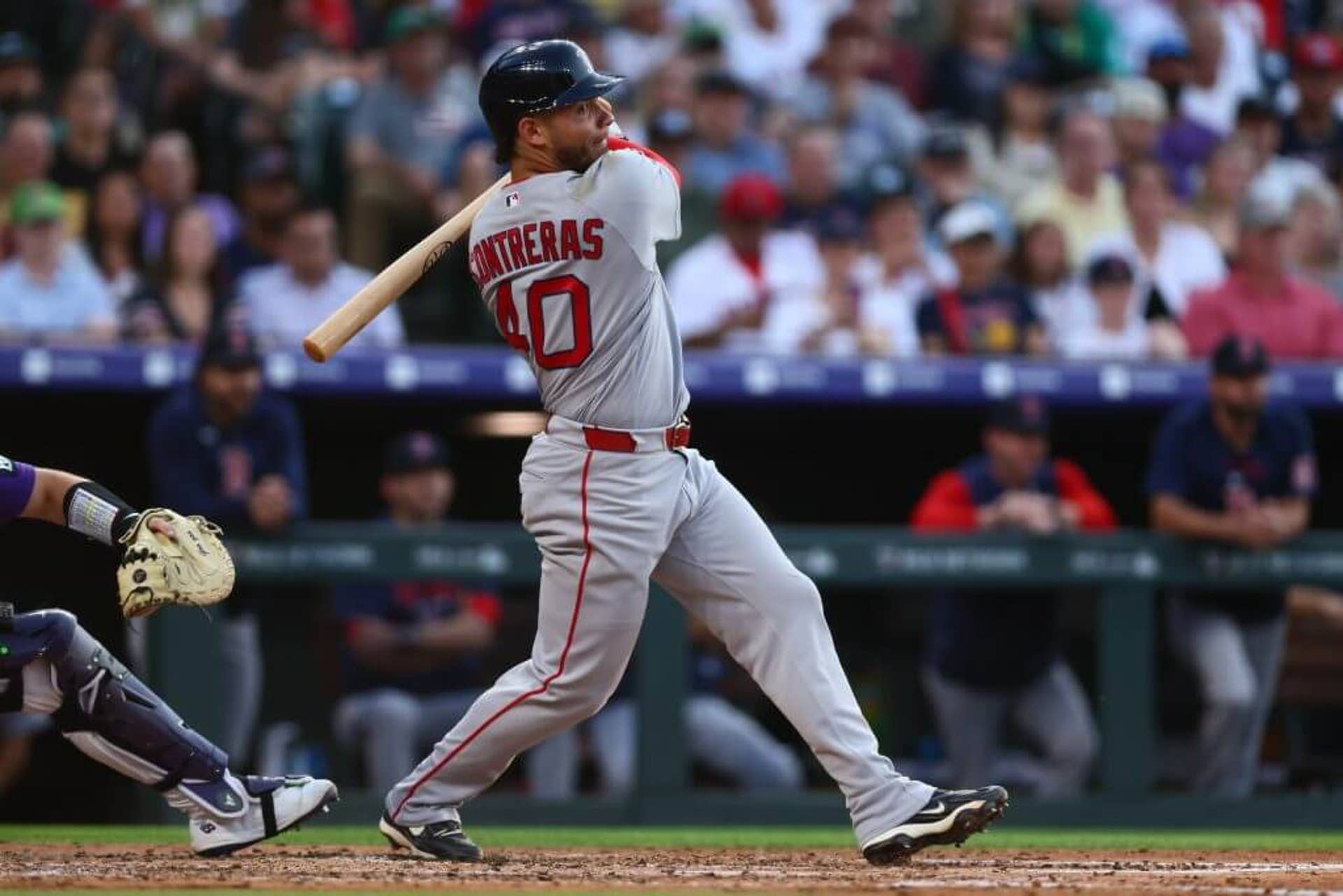 Willson Contreras of the Boston Red Sox hits an RBI double in the sixth inning against the Colorado Rockies at Coors Field on June 22, 2026.