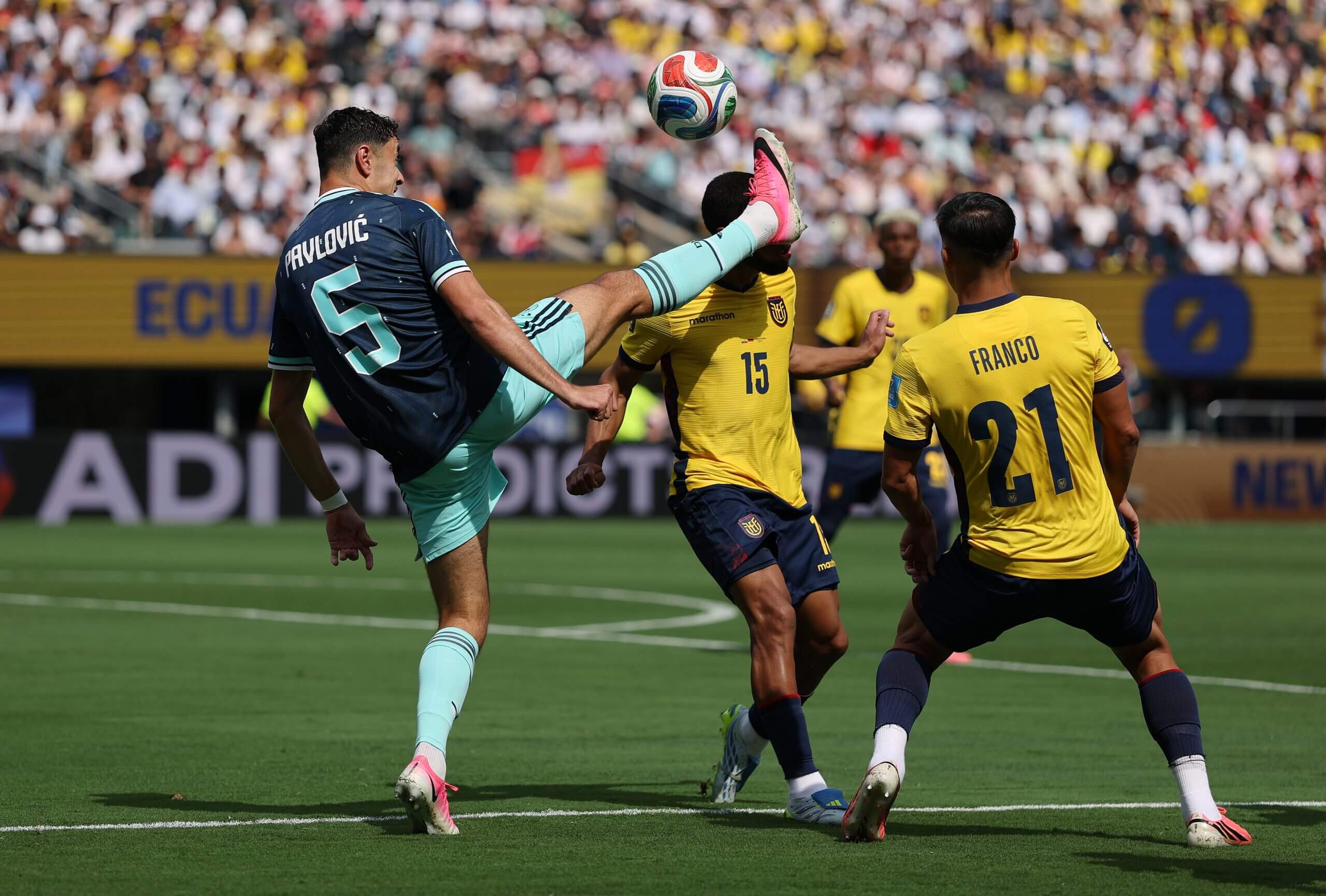 Aleksandar Pavlovic raises his foot high to challenge Ecuador's Pedro Vite