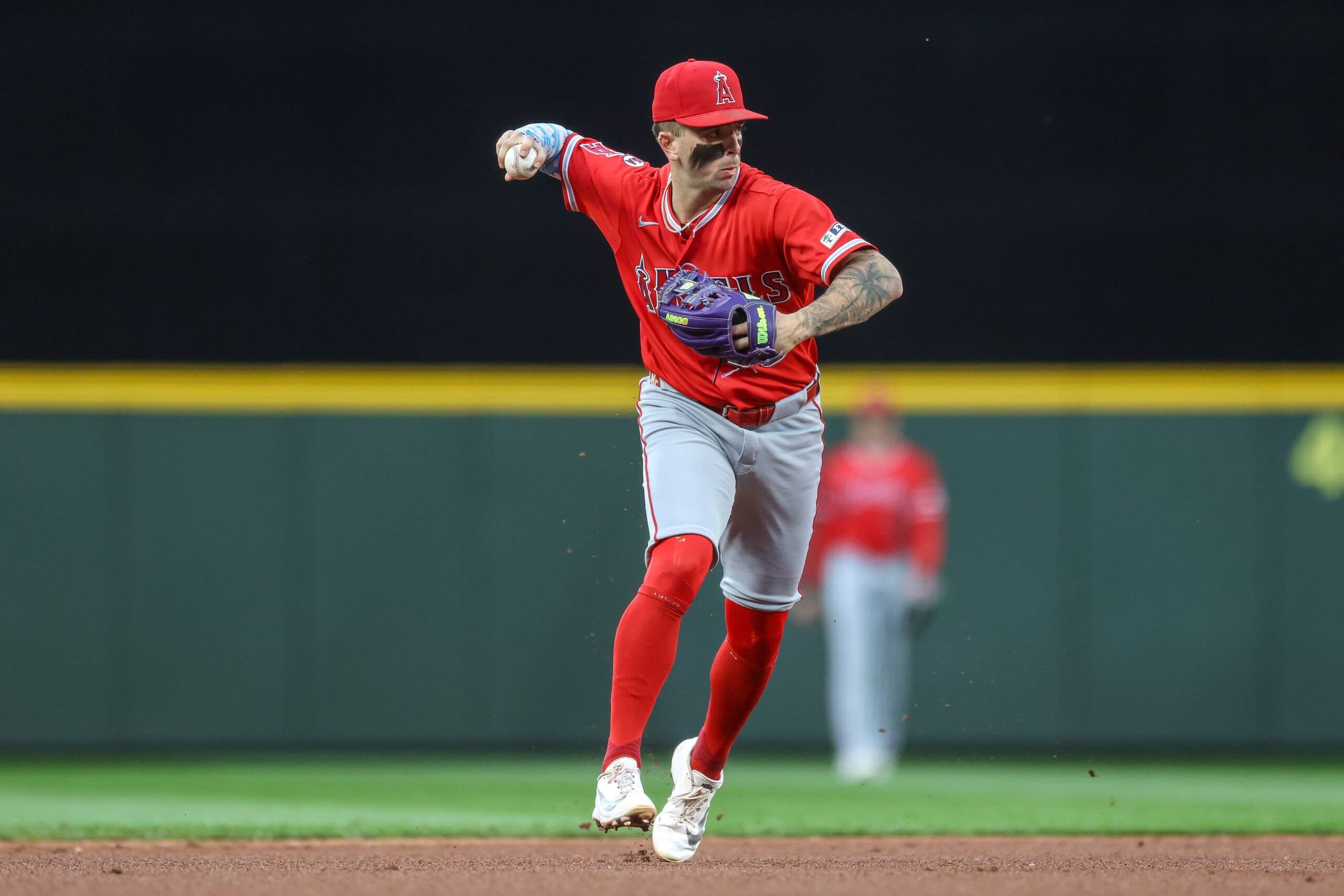Zach Neto throws out a runner during a baseball game.