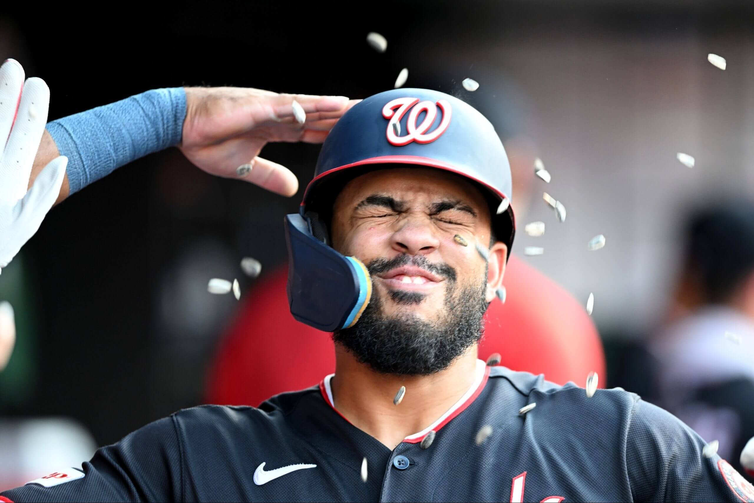Luis García Jr. celebrates in the dugout after hitting a home run.