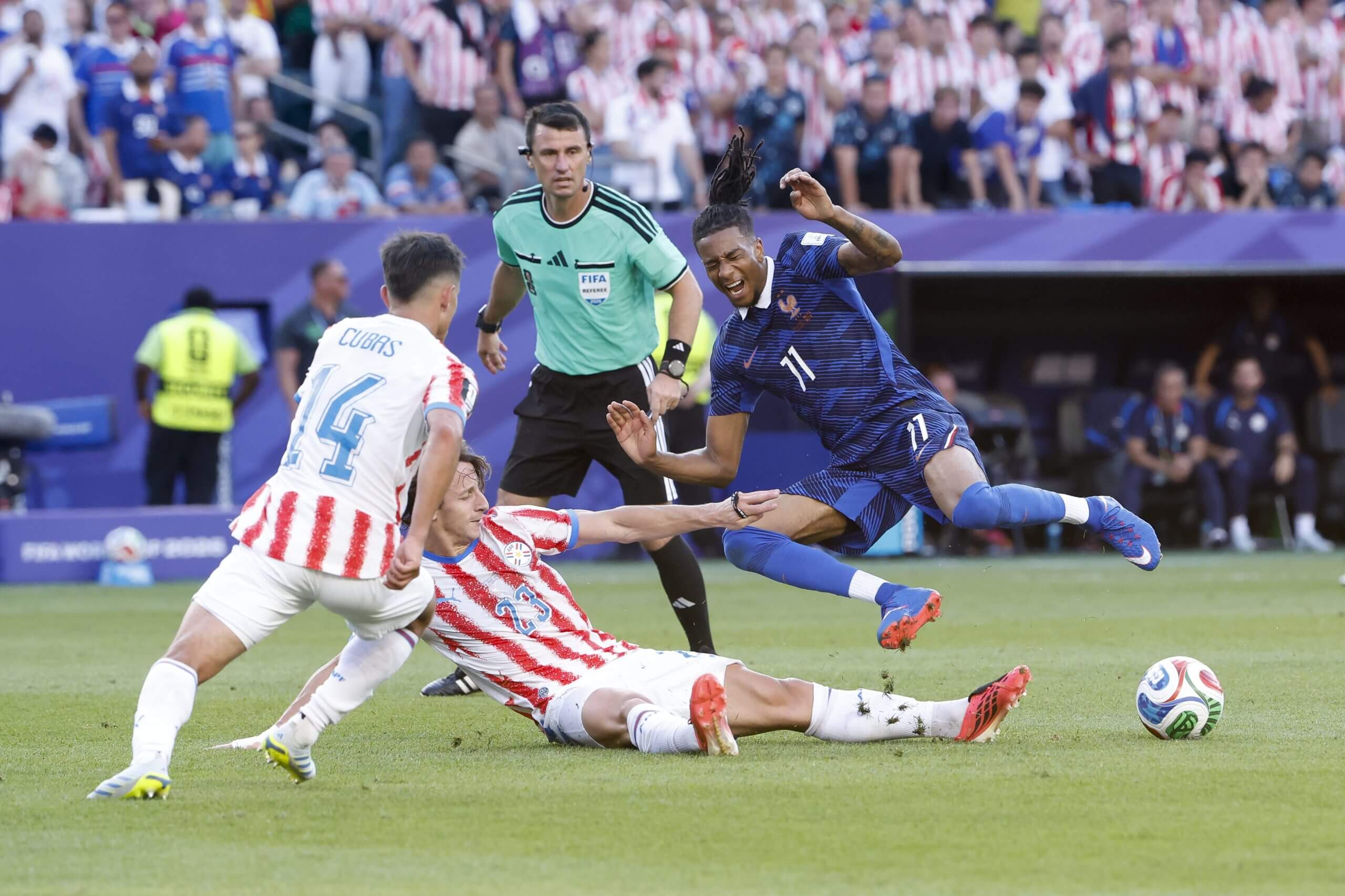 Paraguay's Matias Galarza sends Michael Olise flying into the air with a sliding challenge