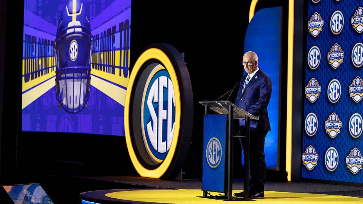 Greg Sankey speaks at a podium at SEC Football Media Day in Tampa, Florida.