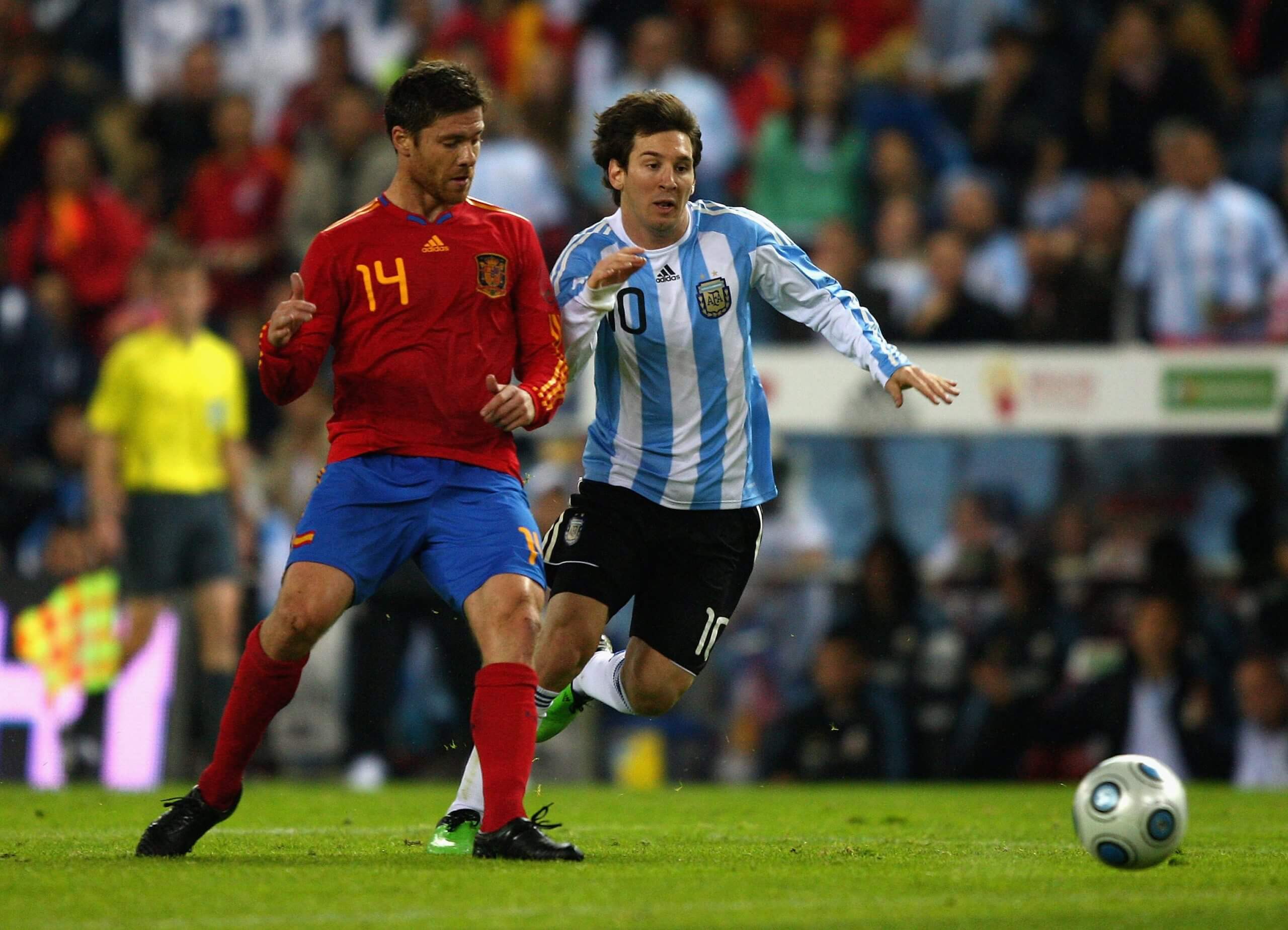 Messi and Xabi Alonso contest a loose ball in a 2009 friendly