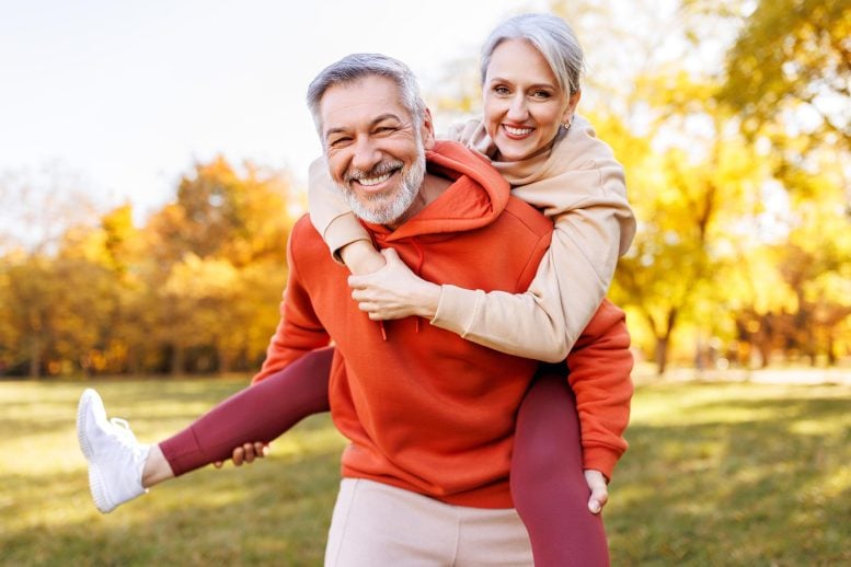 Happy Senior Couple Smiling Piggyback Park Fall Fitness