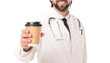 Happy Smiling Doctor Holding Coffee Cup