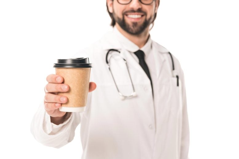 Happy Smiling Doctor Holding Coffee Cup