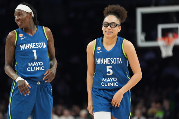 Minnesota Lynx forward Natasha Howard (1) and guard Olivia Miles (5) wait for play to resume during the first half of a WNBA basketball game against the Toronto Tempo Thursday, May 21, 2026, in Minneapolis. (AP Photo/Abbie Parr)