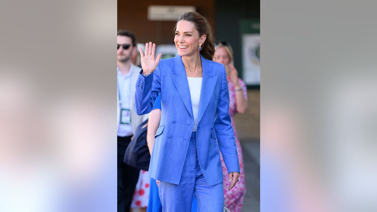Kate Middleton wearing a bold blue blazer and matching pants waving at Wimbledon.