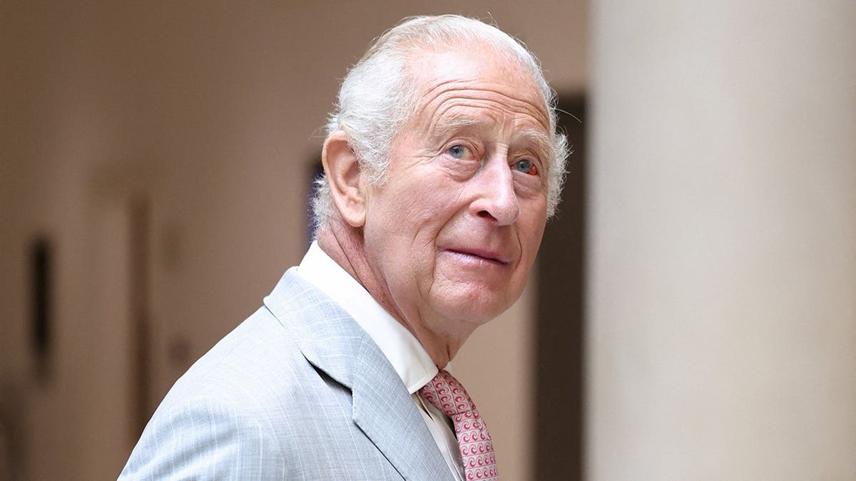 King Charles III stands during a visit at the University of Oxford.