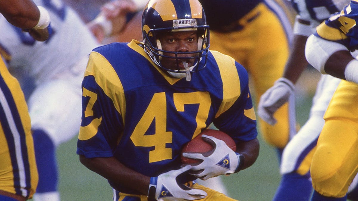 LeRoy Irvin on field with football